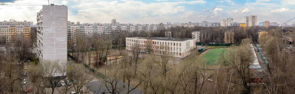 モスクワの典型的な地区の窓からのパノラマビュー春に学校やパネルと5階建ての家を持つTushino — ストック写真