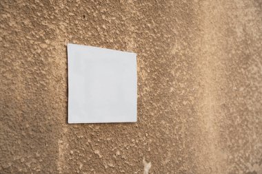 Turuncu beton duvar manzaralı beyaz boş bir plaka.