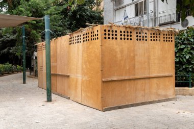 Yahudi bayramı boyunca İsrail 'in Rishon Lezion kentindeki bir yerleşim yerinin bahçesindeki tahta sukkah.