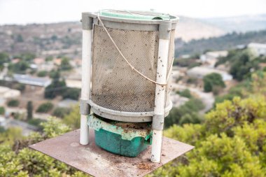 Outdoor trap for flies and other insects in Israeli village clipart