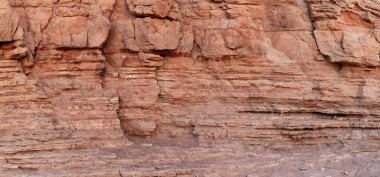 İsrail 'in Eilat kenti yakınlarındaki kırmızı kanyonda kumtaşı bir duvar parçasıyla arka plan