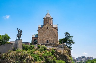 Metekhi church and monument of King Vakhtang Gorgasali on cliff in old town of Tbilisi, Georgia. Virgin Mary Assumption Church of Metekhi is Georgian Orthodox Christian church on bank of river Kura.