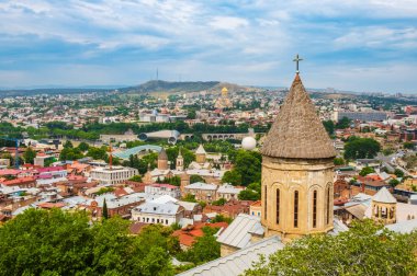 Tbilisi old town with ancient churches and modern architecture, Georgia. Cityscape with Upper Betlemi Church Cathedral, bridge of peace, Rike park. Popular tourist attractions in Tiflis.