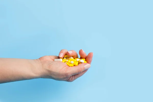 Wiele Białych Żółtych Tabletek Ręce Kobiety Niebieskim Tle Medyczne Pojęcie — Zdjęcie stockowe