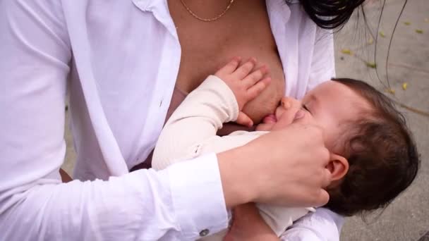 Latin Mom Feeding Her Happy Baby Outdoors — Stock Video