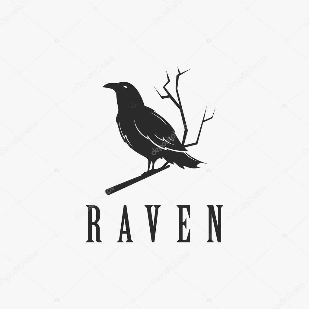 Black raven logo hanging on dead tree branch design vector on white background