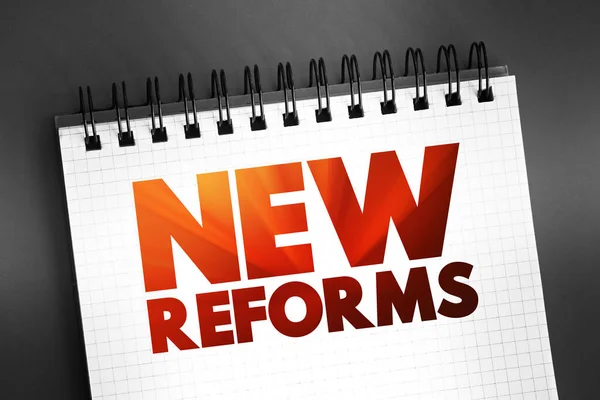 Stock image New Reforms text quote on notepad, concept background