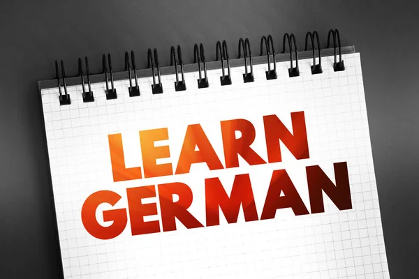 Learn German text quote on notepad, concept background