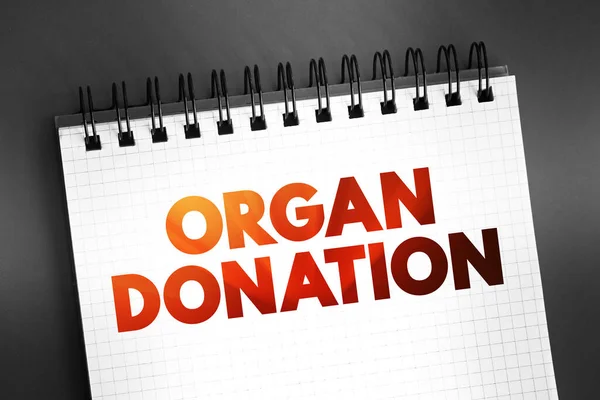 stock image Organ Donation - process of surgically removing an organ or tissue from one person and placing it into another person, text on notepad, concept background