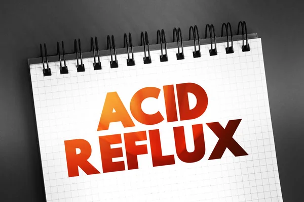 Acid reflux - common condition that features a burning pain, known as heartburn, in the lower chest area, text concept on notepad
