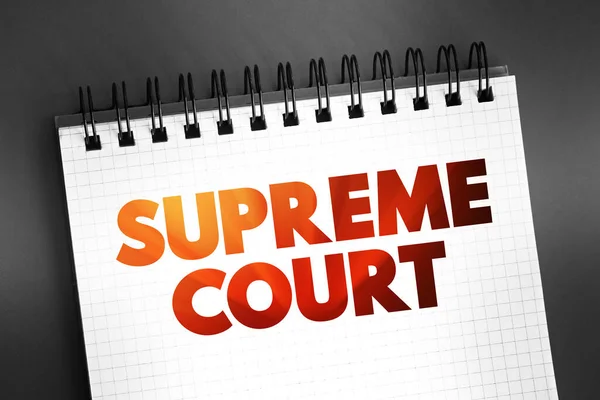 Supreme Court - highest court in the federal judiciary, text on notepad, concept background