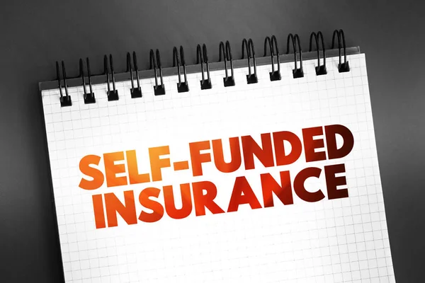 Self Funded Insurance - type of plan in which an employer takes on most or all of the cost of benefit claims, text on notepad, concept background