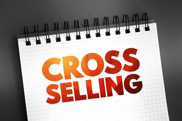 Cross Selling - action or practice of selling an additional product or service to an existing customer, text quote on notepad
