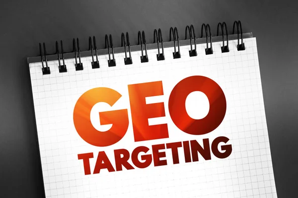 Geo Targeting - method of delivering different content to visitors based on their geolocation, text concept on notepad