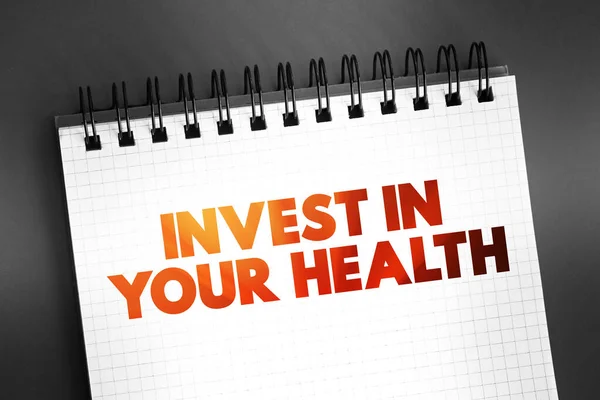 Invest In Your Health text quote on notepad, concept background