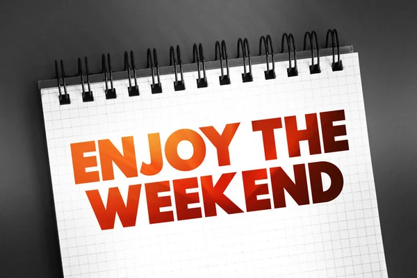 Enjoy the Weekend text quote on notepad, concept background