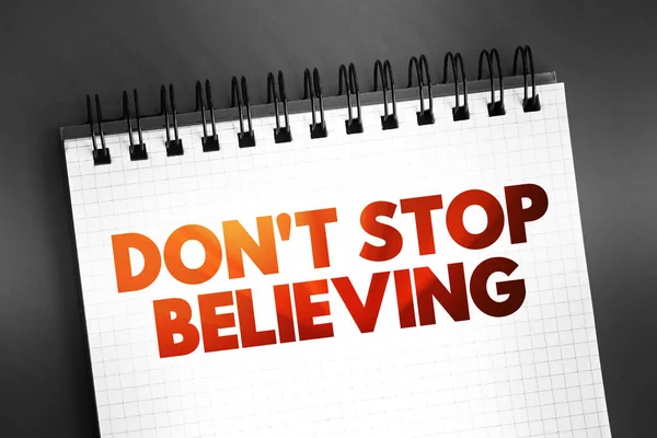 Don\'t Stop Believing text quote on notepad, concept background