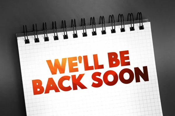 stock image We'll Be Back Soon text quote on notepad, concept background