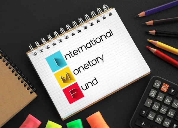 IMF - International Monetary Fund acronym on notepad, business concept background