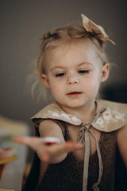 the girl prepares tea in the children's kitchen