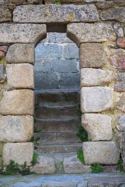 Stone arch with stairs to climb bell tower of church of Santa Maria in Hervas vertical