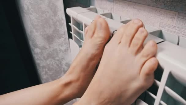 Female Bare Feet Touch Heating Radiator Trying Keep Warm Concept — Vídeo de stock