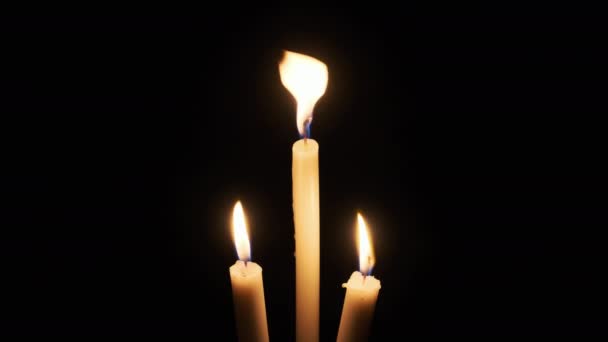 Three Candle Burns Black Background Yellow Flame Flickering Candles Illuminates — Vídeos de Stock