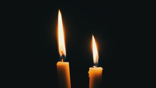 Two Candles Burn Black Background Yellow Flickering Candles Illuminates Darkness — Vídeos de Stock