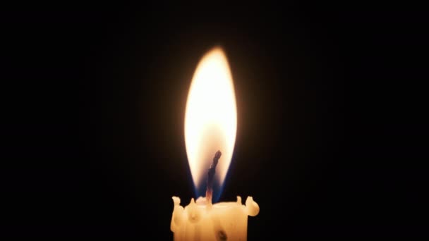 One Candle Lit Black Background Close Yellow Flickering Flame Illuminates — Wideo stockowe