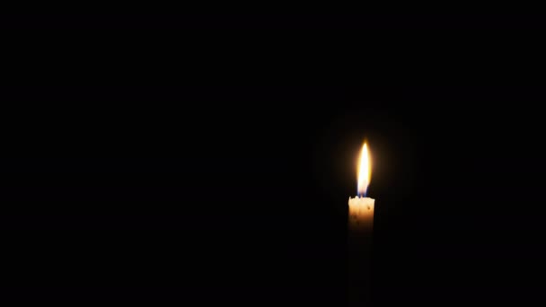 Candle Burns Black Background Yellow Single Flickering Candle Illuminates Darkness — Vídeo de stock