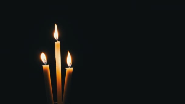 Three Candle Burns Black Background Yellow Flame Flickering Candles Illuminates — Vídeo de stock