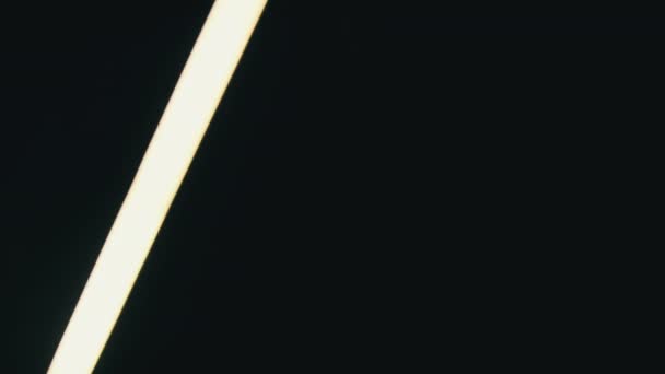 Neon Led Sword Moves Side Side Black Background Bright White — Video