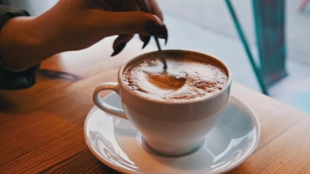 Girl Hand Stirs Foam Spoon Cappuccino Mug Overlooking Cold Street — Video