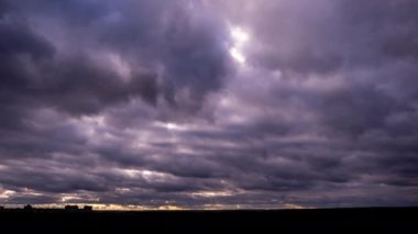 Timelapse of dark storm clouds moving in the sky at evening. Winter cloudy space with dark dramatic clouds changing shape. Atmosphere background, time lapse. Change of weather. Nature, copy space, 4K