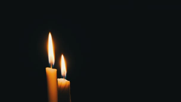 Two Candles Burn Black Background Yellow Flickering Candles Illuminates Darkness — Vídeo de stock
