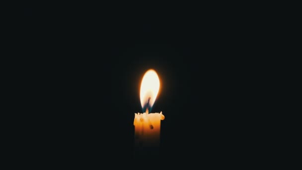 One Candle Lit Black Background Close Yellow Flickering Flame Illuminates — Stock videók