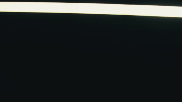 Neon Led Sword Moves Side Side Black Background Bright White — Video