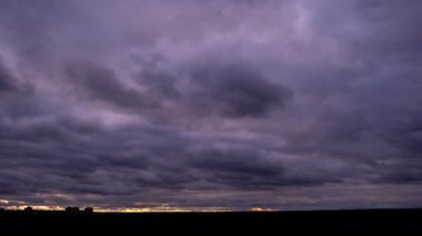Timelapse of dark storm clouds moving in the sky at evening. Winter cloudy space with dark dramatic clouds changing shape. Atmosphere background, time lapse. Change of weather. Nature, copy space, 4K