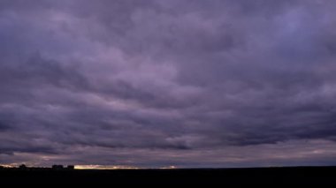 Timelapse of dark storm clouds moving in the sky at evening. Winter cloudy space with dark dramatic clouds changing shape. Atmosphere background, time lapse. Change of weather. Nature, copy space, 4K