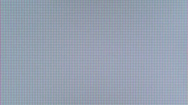 Macro view of a television LED screen with RGB sub-pixels. Colored pixels in close-up create an abstract pattern. Red, blue, and green LCD pixels background of VA matrix of 4K TV. Closeup monitor.