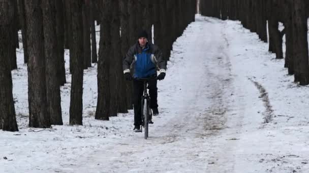 Man Ride Bicycle Snowy Path Winter Trees Slow Motion Young — Stock Video