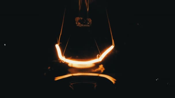 Tungsten Filament Incandescent Bulb Glows Flickers Close Black Background Lamp — стоковое видео