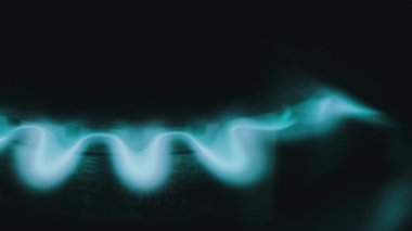 Burning blue flame of gas on a kitchen stove in macro. Ignited gas on a burner close-up. Flame of natural gas burner operation. Fire on the Stove. Circular gas-jet.