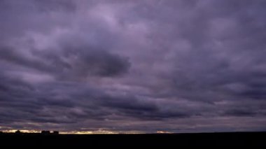 Timelapse of dark storm clouds moving in the sky at evening. Winter cloudy space with dark dramatic clouds changing shape. Atmosphere background, time lapse. Change of weather. Nature, copy space, 4K
