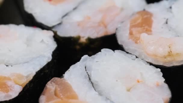 Japanese Sushi Rolls Plastic Box Rotating Close Takeaway Fresh Sushi — стоковое видео