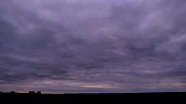 Timelapse of dark storm clouds moving in the sky at evening. Winter cloudy space with dark dramatic clouds changing shape. Atmosphere background, time lapse. Change of weather. Nature, copy space, 4K