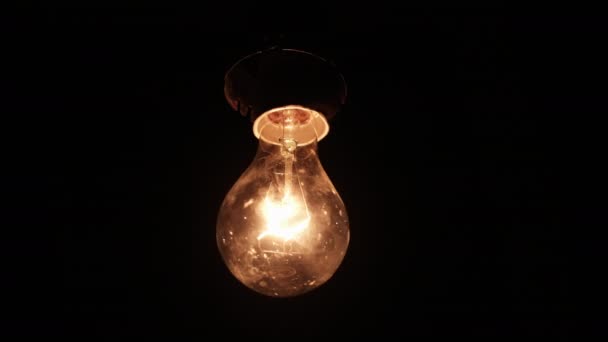 Hanging Incandescent Bulb Turns Flickers Black Background Place Text Warm — ストック動画