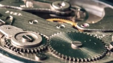 Timelapse of mechanism of vintage stopwatch with rotation close-up. Round clock watch mechanism working, macro. Old retro clockwork gears, cogwheels, and pendulum movement inside the ancient clock. 4K