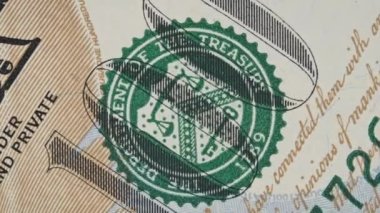 Fragment of one hundred dollar bill rotates close-up. 100 US banknote spinning in extreme macro. High-resolution view of USD currency. Business, investment, fiat money, finance. Cash money background.