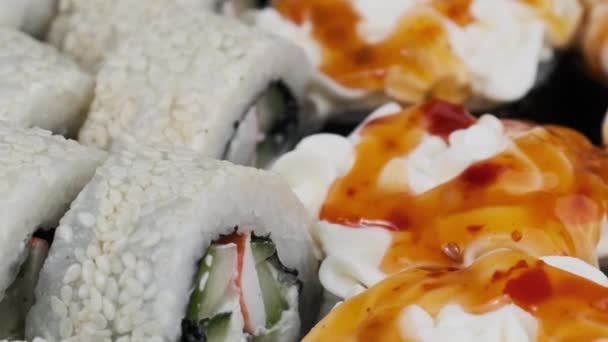 Japanese Sushi Rolls Plastic Box Rotating Close Takeaway Fresh Sushi — Video
